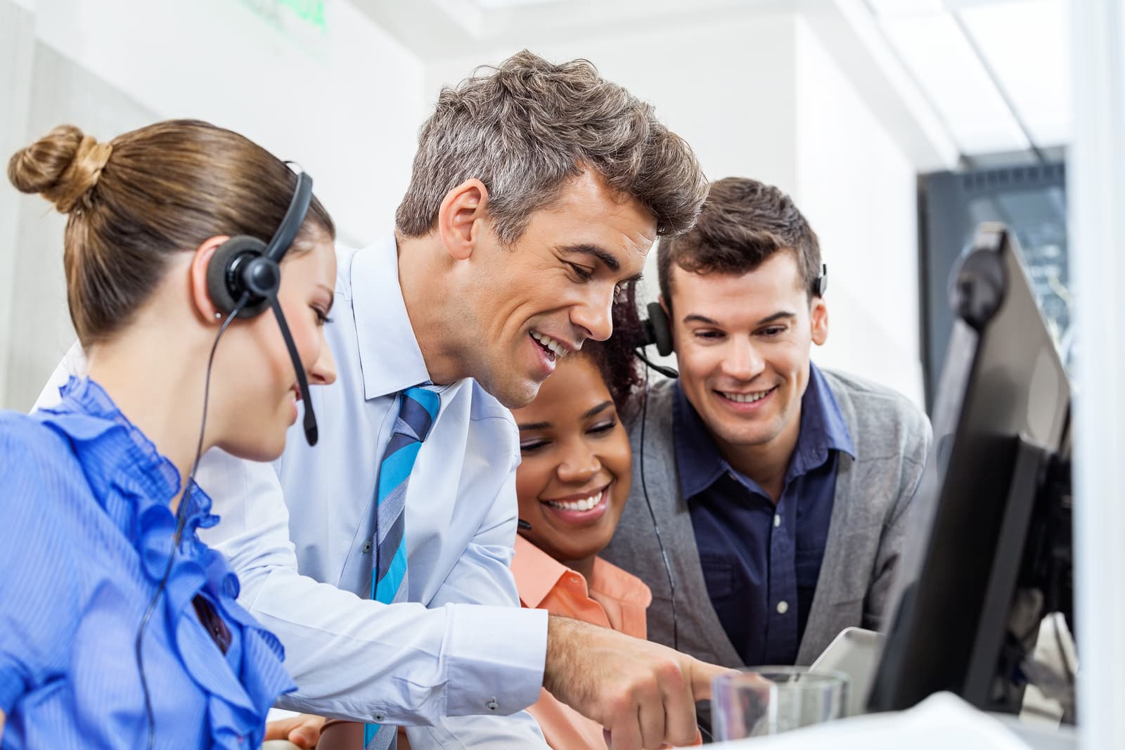 Customer support representative assisting a client over the phone in an office